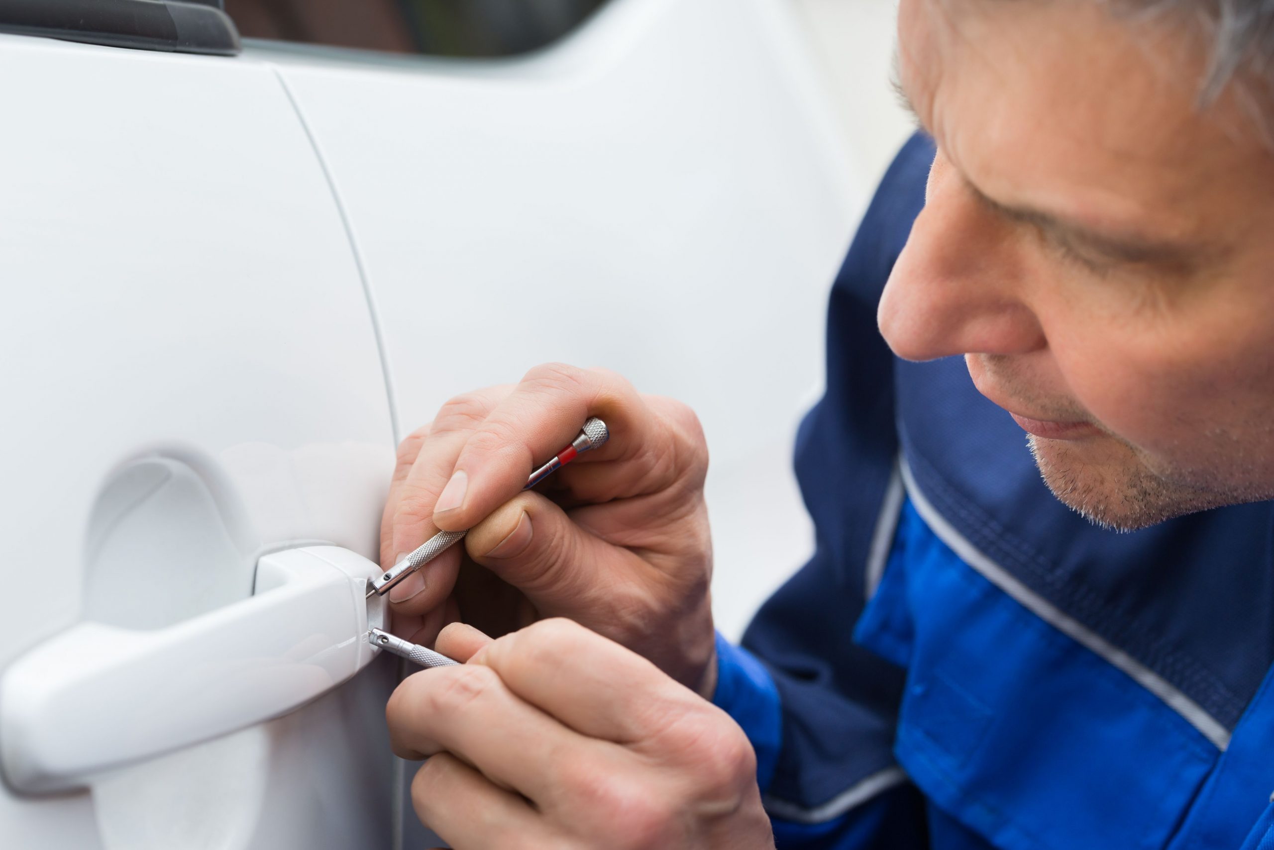 locksmith unlocking lock on vehicle