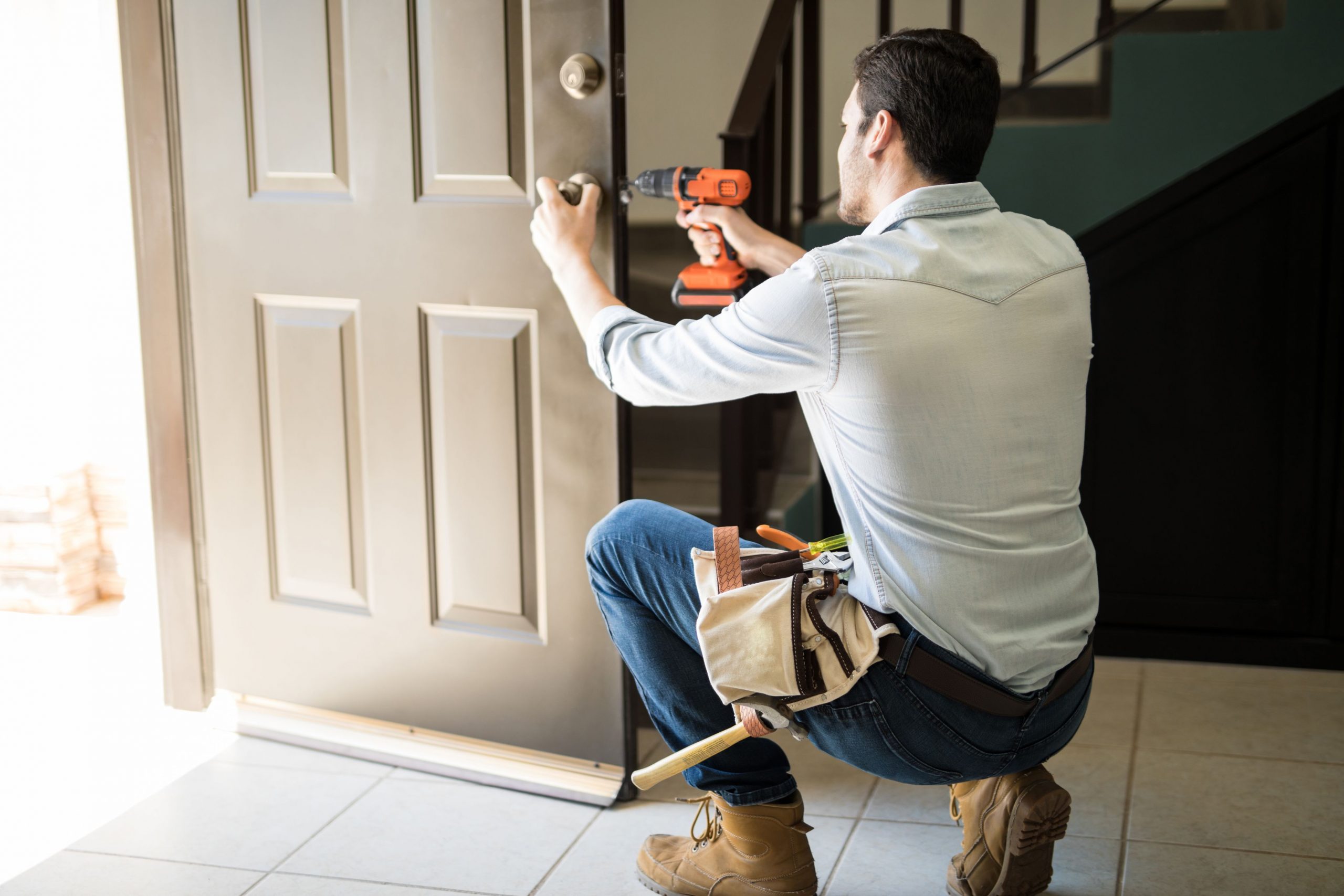 man repairing residential door lock