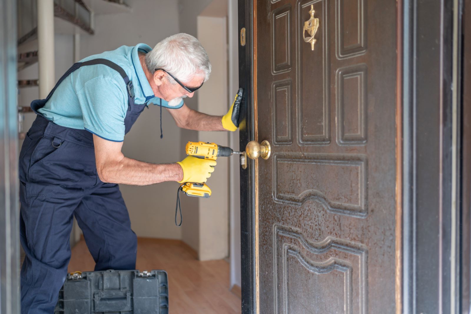 man fixing a residential door lock